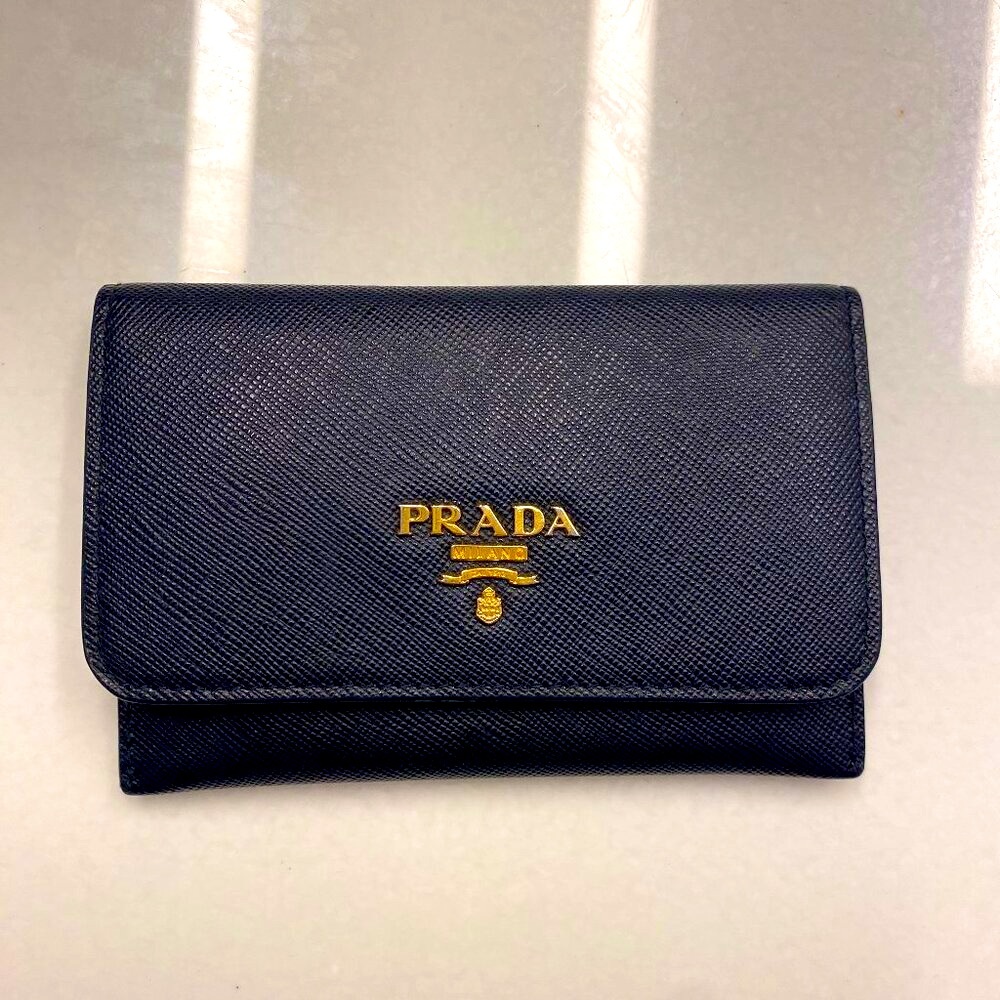 Prada Saffiano leather credit card holder with gold-toned Prada lettering.